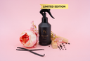 Black spray bottle labeled 'Velvet Home' with flowers and vanilla beans on a pink background, featuring 'Limited Edition' text.
