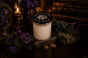 Black Vintage Single Wick candle on a dark background with flowers and books