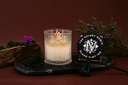 Black Velvet Single Wick candle on a dark tray with decorative elements.