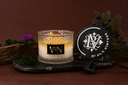 Black Vintage 2 Wick candle with decorative elements on a dark surface