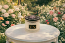 Candle on a white table with a floral background