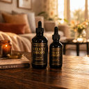 Two bottles of 'Velvet Drops' on a wooden table with a cozy living room background.