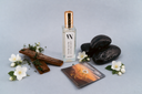 Mini Air & Linen Mist with decorative stones, flowers, and branches on a light gray background