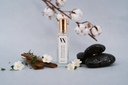 Mini Air & Linen Mist with decorative stones, flowers, and branches on a light gray background