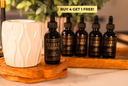 Bottle of Velvet Drops on a wooden tray with a white ceramic container and more bottles in the background. Banner that says "Buy 4 Get 1 Free!"