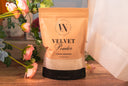 Package of Velvet Powder with flowers in the background