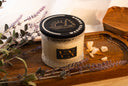 Washed Amber Two wick candle on a wooden tray with amber and lavender.