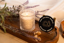 Washed Amber single wick candle on a wooden tray with amber and lavender.