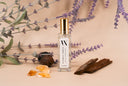Mini Air & Linen mist with lavender and amber elements on a beige background