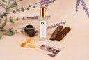 Mini Air & Linen mist with lavender and amber elements on a beige background