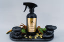 Spray bottle labeled 'Velvet Sparkle' on a decorative stone tray with leaves against a light gray background.