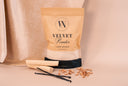 Package of 'Velvet Powder' with vanilla beans on a beige background