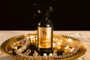 Spray bottle labeled 'Velvet Sparkle' on a decorative tray with crystals