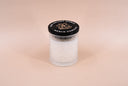 Vanilla candle with a black lid on a beige background