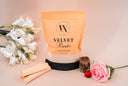 Package of 'Velvet Powder' with decorative flowers on a beige background