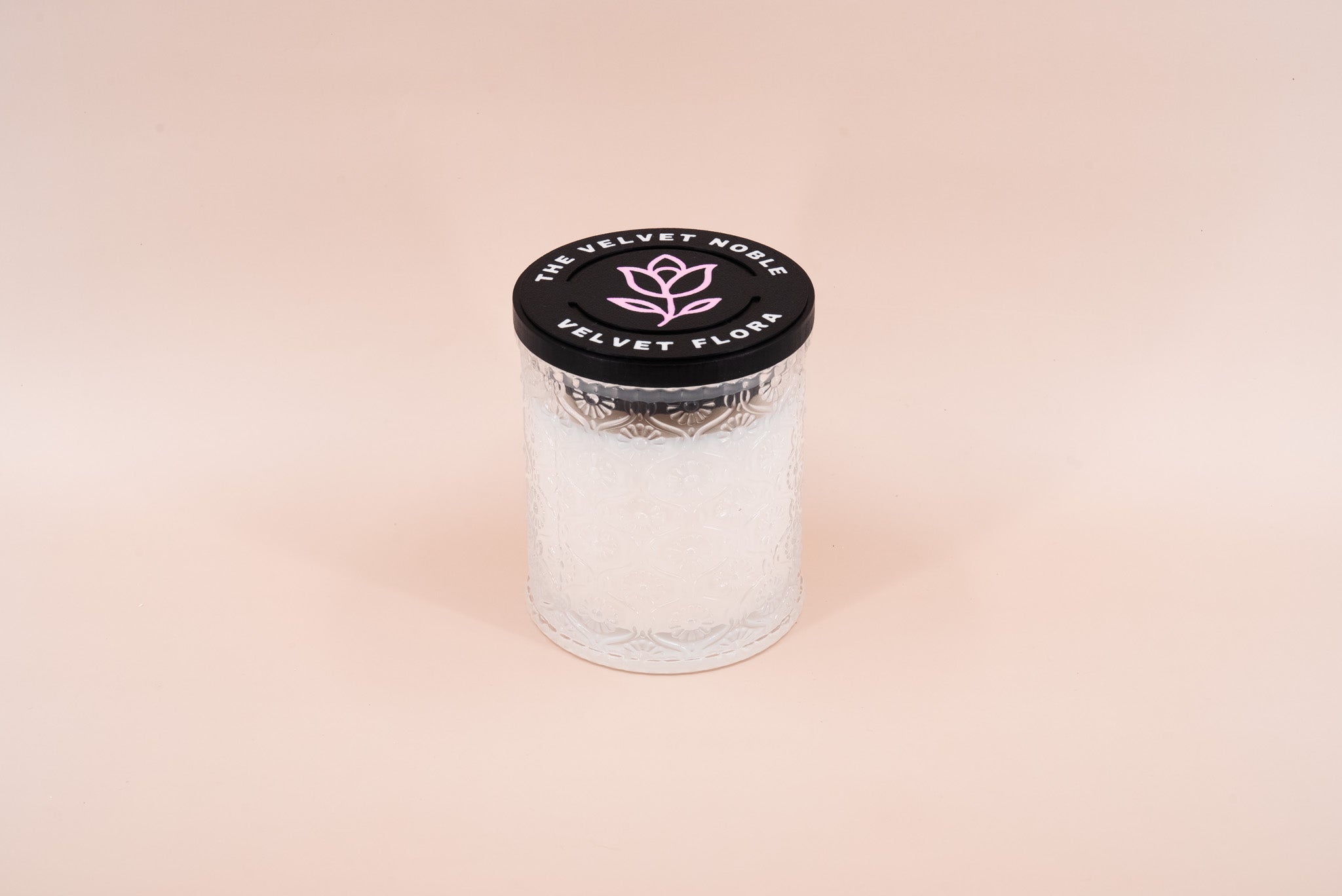 Velvet Flora Candle on a beige background.