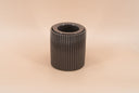 A dark brown ribbed fragrance warmer with a small warmer cup, set against a solid beige background.