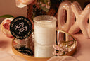 Sugared Legacy Candle on a pink background with flowers