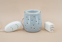 Light Blue fragrance warmer on a beige background with plug and warmer controls.
