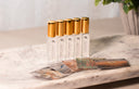 5 Small Air & Linen Mist bottles with golden caps. Velvet Stacks, Noble Coast, Noble Vanilla, Velvet Flora, & Clean Slate.