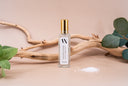 Mini Air & Linen Mist Bottle on a beige background with Sea Salt, Mint, Eucalyptus, and a stick.