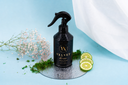 Black spray bottle labeled 'Velvet Home' on a blue background with decorative elements.