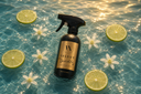Velvet Sparkle Multipurpose Spray in a pool of fresh, clear water with Citrus and flowers.