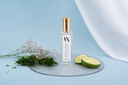 Mini Air & Linen Mist bottle of 'Morning Mist' with decorative elements on a blue background
