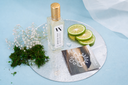 Mini Air & Linen Mist bottle of 'Morning Mist' with decorative elements on a blue background