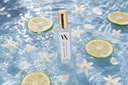 Morning Mist Mini Air & Linen Mist with lime slices and flowers on a water surface