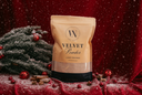 Velvet Powder on a red fabric surface with cinnamon, berries, red jingle bells and a snowy branch.