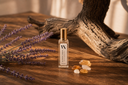 Washed Amber Mini Air & Linen Mist with lavender and amber on a wooden surface